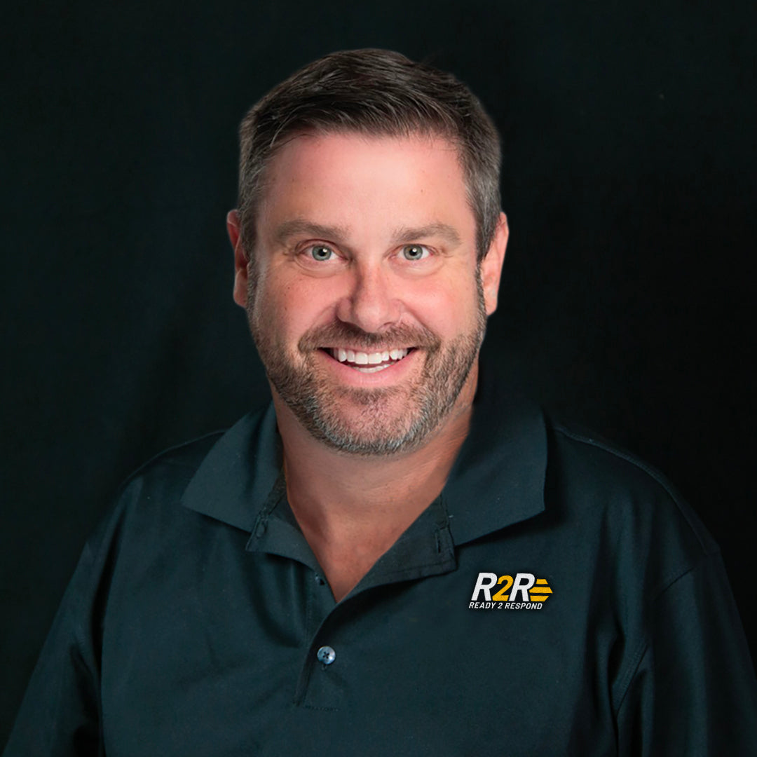 Man wearing a dark polo shirt with a Ready to Respond from Legend Brands logo on a black background